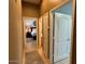 Hallway view into bedroom with styled bed; neutral interior paint and flooring at 9900 E Desert Trail Ln, Gold Canyon, AZ 85118