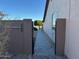 Side yard featuring a brick pathway, a tree and shrub, and the side of the house at 9900 E Desert Trail Ln, Gold Canyon, AZ 85118