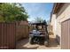 This side yard with gravel and a narrow pathway has a gate offering utility and privacy at 9900 E Desert Trail Ln, Gold Canyon, AZ 85118