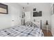 Bedroom with a metal bed frame, TV, and wood flooring at 1002 E Palm Ln, Phoenix, AZ 85006