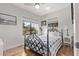 Bright bedroom with a metal bed frame and wood flooring at 1002 E Palm Ln, Phoenix, AZ 85006
