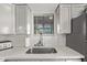 Modern kitchen features white cabinets, stainless steel sink, and quartz countertops at 1002 E Palm Ln, Phoenix, AZ 85006