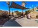 Relaxing patio area with shade sail, comfortable seating, and games at 1002 E Palm Ln, Phoenix, AZ 85006