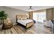 This bedroom offers a fan, patterned wall, and a comfortable queen bed with plush pillows at 10546 E Topaz Cir, Scottsdale, AZ 85258