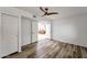 Empty bedroom with wood-look floors and open doorway to the living room at 10546 E Topaz Cir, Scottsdale, AZ 85258