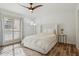 Light and airy bedroom with a queen-size bed and wood floors at 10546 E Topaz Cir, Scottsdale, AZ 85258