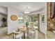 Bright dining area with view to yard, light fixture, and table set for four at 10546 E Topaz Cir, Scottsdale, AZ 85258