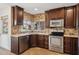 Kitchen with corner sink and stainless steel appliances at 10546 E Topaz Cir, Scottsdale, AZ 85258