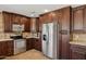 Modern kitchen featuring stainless steel appliances and dark wood cabinetry at 10546 E Topaz Cir, Scottsdale, AZ 85258