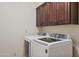 Laundry room with washer, dryer, and cabinets at 10546 E Topaz Cir, Scottsdale, AZ 85258
