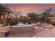 Landscaped backyard with a swimming pool and patio at 1078 W Spur Ct, Gilbert, AZ 85233