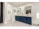 Double vanity bathroom with navy blue cabinets and marble flooring at 1078 W Spur Ct, Gilbert, AZ 85233