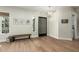 Bright and airy entryway with wood floors and modern light fixture at 1078 W Spur Ct, Gilbert, AZ 85233