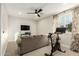 Bright exercise room with Peloton bike and comfy couch at 1078 W Spur Ct, Gilbert, AZ 85233