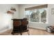 Charming home bar with two brown leather stools and a view of the backyard at 1078 W Spur Ct, Gilbert, AZ 85233