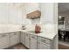 Modern kitchen with white cabinets, gray lower cabinets, and hexagon backsplash at 1078 W Spur Ct, Gilbert, AZ 85233