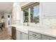 Modern kitchen with white farmhouse sink, quartz countertops, and gold faucet at 1078 W Spur Ct, Gilbert, AZ 85233