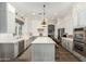 Modern kitchen with white and gray cabinets, a large island, and gold lighting at 1078 W Spur Ct, Gilbert, AZ 85233