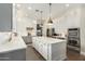 Modern kitchen with white and gray cabinets, large island, and stainless steel appliances at 1078 W Spur Ct, Gilbert, AZ 85233