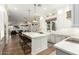 Open concept kitchen with white cabinets, center island, and breakfast bar at 1078 W Spur Ct, Gilbert, AZ 85233