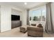 Comfortable sitting area with a large TV and cozy armchair at 1078 W Spur Ct, Gilbert, AZ 85233