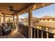 Relaxing balcony with ceiling fan and comfortable seating, overlooking community at 1094 S Agnes Ln, Gilbert, AZ 85296