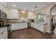 Modern kitchen with white cabinets, granite counters, and stainless steel appliances at 1094 S Agnes Ln, Gilbert, AZ 85296