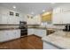 Modern kitchen with white cabinets, granite countertops, and stainless steel appliances at 1094 S Agnes Ln, Gilbert, AZ 85296