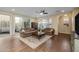 Living room with hardwood floors, sofas, and access to patio at 1094 S Agnes Ln, Gilbert, AZ 85296