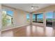Bright bedroom with wood floors, large windows, and a balcony overlooking the mountains at 14829 N 18Th Pl, Phoenix, AZ 85022