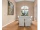 Bright dining room features hardwood floors, a chandelier, and a large window with a view at 14829 N 18Th Pl, Phoenix, AZ 85022