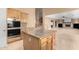Open kitchen with granite island, stainless steel appliances, and views to the Gathering room at 14829 N 18Th Pl, Phoenix, AZ 85022