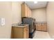 Laundry room with washer, dryer, cabinets, and countertop at 14829 N 18Th Pl, Phoenix, AZ 85022