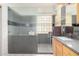 Bathroom with a walk-in shower, glass block accents, and a granite countertop at 1493 E Robinson Way, Chandler, AZ 85225