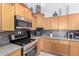 This kitchen features wood cabinets, stainless steel appliances, and stylish countertop at 1493 E Robinson Way, Chandler, AZ 85225