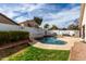 Backyard with a refreshing in-ground pool, ample patio space, and privacy fencing at 1493 E Robinson Way, Chandler, AZ 85225