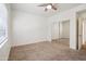Cozy carpeted bedroom with mirrored closet doors and ceiling fan at 15050 N Thompson Peak Pkwy # 2033, Scottsdale, AZ 85260
