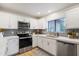 Updated kitchen, featuring white cabinets and stainless steel appliances at 15050 N Thompson Peak Pkwy # 2033, Scottsdale, AZ 85260