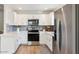 Modern kitchen with white cabinets, stainless steel appliances, and gray backsplash at 15050 N Thompson Peak Pkwy # 2033, Scottsdale, AZ 85260