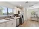 Modern kitchen with white cabinets, stainless steel appliances, and gray tile backsplash at 15050 N Thompson Peak Pkwy # 2033, Scottsdale, AZ 85260