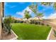 Landscaped backyard with artificial turf and seating at 15348 W Banff Ln, Surprise, AZ 85379