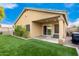 Spacious backyard with artificial turf and covered patio at 15348 W Banff Ln, Surprise, AZ 85379