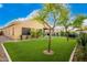 Artificial turf backyard with home view at 15348 W Banff Ln, Surprise, AZ 85379