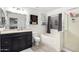 Bathroom with soaking tub, shower, and dark vanity at 15348 W Banff Ln, Surprise, AZ 85379