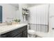 Bathroom with shower/tub combo and dark vanity at 15348 W Banff Ln, Surprise, AZ 85379