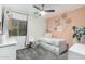 Cozy bedroom boasts soft peach wall, window, and plush carpeting for ultimate relaxation at 15348 W Banff Ln, Surprise, AZ 85379