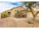 Tan house with a two-car garage and landscaping at 15348 W Banff Ln, Surprise, AZ 85379