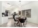 Modern kitchen with white cabinets, black appliances, and breakfast nook at 15348 W Banff Ln, Surprise, AZ 85379