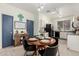 Modern kitchen with white cabinets and a wooden dining table at 15348 W Banff Ln, Surprise, AZ 85379