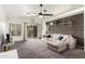 Living room with gray sectional sofa and wood accent wall at 15348 W Banff Ln, Surprise, AZ 85379